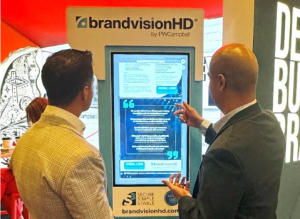 Ben Mahtani, Chief Technology Officer (right), uses the Branch Hub to discuss BrandVisionHD and other PWCampbell offerings at the Financial Brand Forum. 
